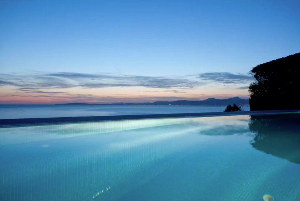 <p>The south-facing home, which is built on top of a cliff, has breathtaking sunset views in the evening and panoramic views of the coast during the day. (Airbnb) </p>