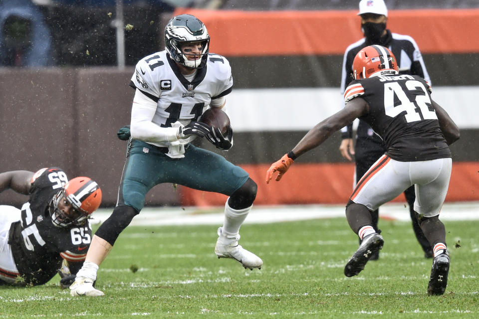 Philadelphia Eagles quarterback Carson Wentz (11) scrambles during the first half of an NFL football game against the Cleveland Browns, Sunday, Nov. 22, 2020, in Cleveland. (AP Photo/David Richard)