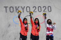 From left, silver medalist Kokona Hiraki of Japan, gold medalist Sakura Yosozumi of Japan and bronze medalist Sky Brown of Britain pose during a medals ceremony for the women's park skateboarding at the 2020 Summer Olympics, Wednesday, Aug. 4, 2021, in Tokyo, Japan. (AP Photo/Ben Curtis)