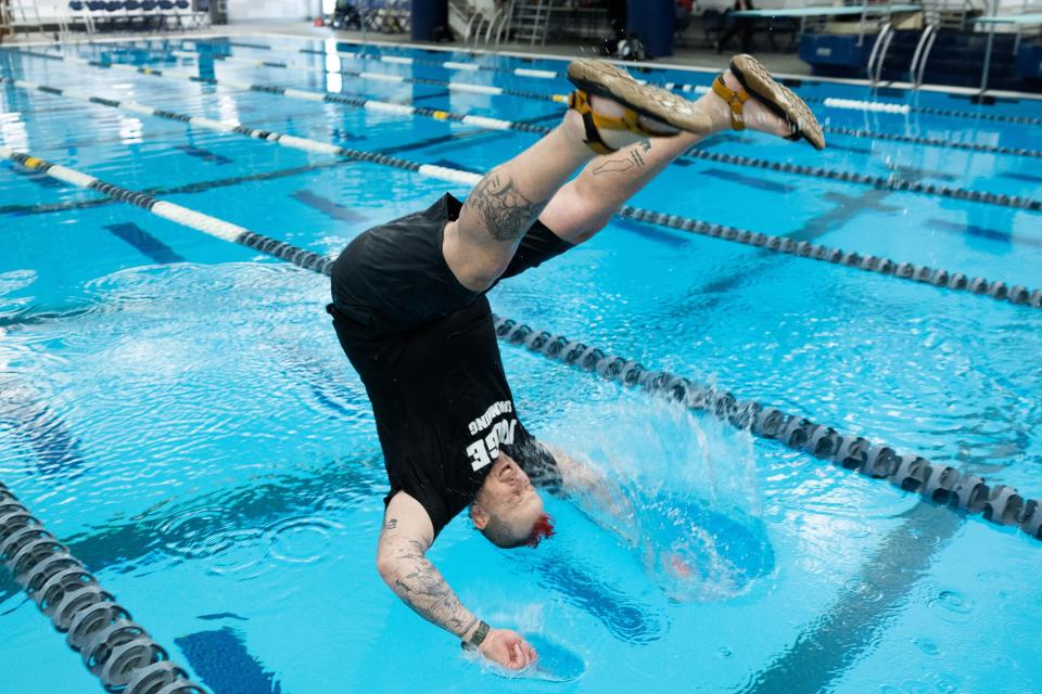 Judge Memorial coach Chad Starks is pushed into the pool after winning both the 3A boys and girls state swimming championships at the Stephen L. Richards Building in Provo on Saturday, Feb. 11, 2023. | Ryan Sun, Deseret News