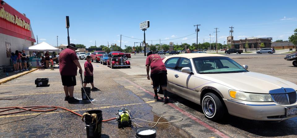 Cars line up to support the Texas Chozen car wash to support 8-year-old shooting victim Nicasio Frausto on Saturday at 4210 SW 45th Ave.