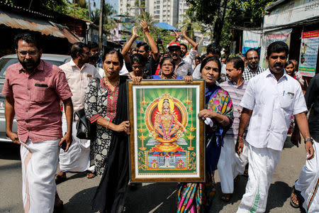 Protesters hold a portrait of Hindu deity “Ayappa” as they take part in a rally called by various Hindu organisations after two women entered the Sabarimala temple, in Kochi, January 2, 2019. REUTERS/Sivaram V