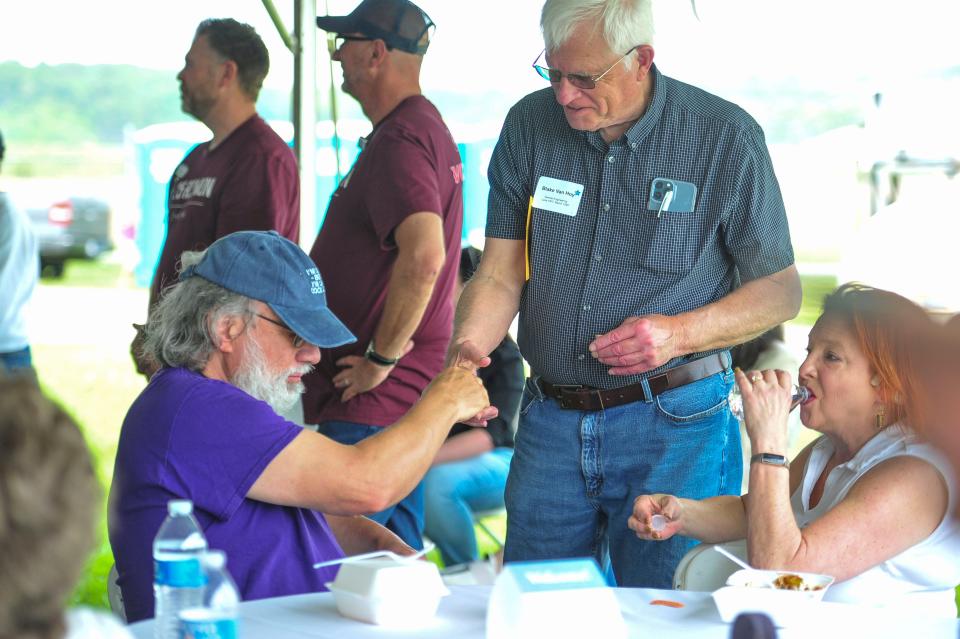 Chuck Agle (left) shakes hands with Blake Van Hoy (right) during the K-25 first annual reunion on Saturday, April 27, 2024 in Oak Ridge, Tenn.