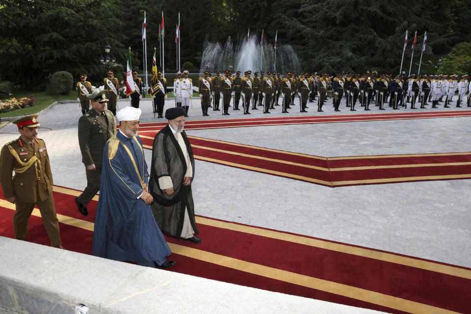 In this photo released by the office of the Iranian Presidency, Oman's Sultan Haitham bin Tariq Al Said, second right, is welcomed by Iranian President Ebrahim Raisi, right, during an official welcoming ceremony at the Saadabad Palace in Tehran, Iran, Sunday, May 28, 2023. Oman has a long record of being a key broker between Iran and the West, amid volatile regional tensions. (Iranian Presidency Office via AP)
