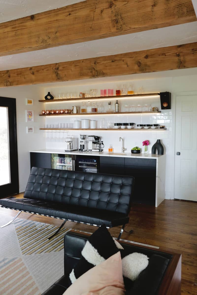 Leather sofa in front of home bar in living room.