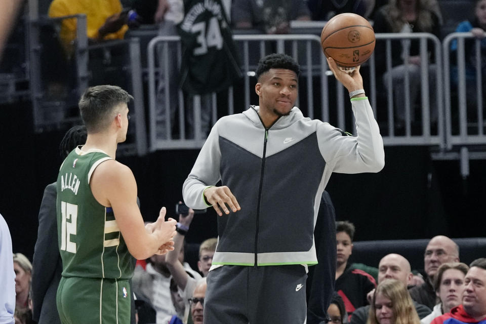 Milwaukee Bucks forward Giannis Antetokounmpo tosses the ball during the second half of an NBA basketball game against the Detroit Pistons, Monday, March 27, 2023, in Detroit. (AP Photo/Carlos Osorio)