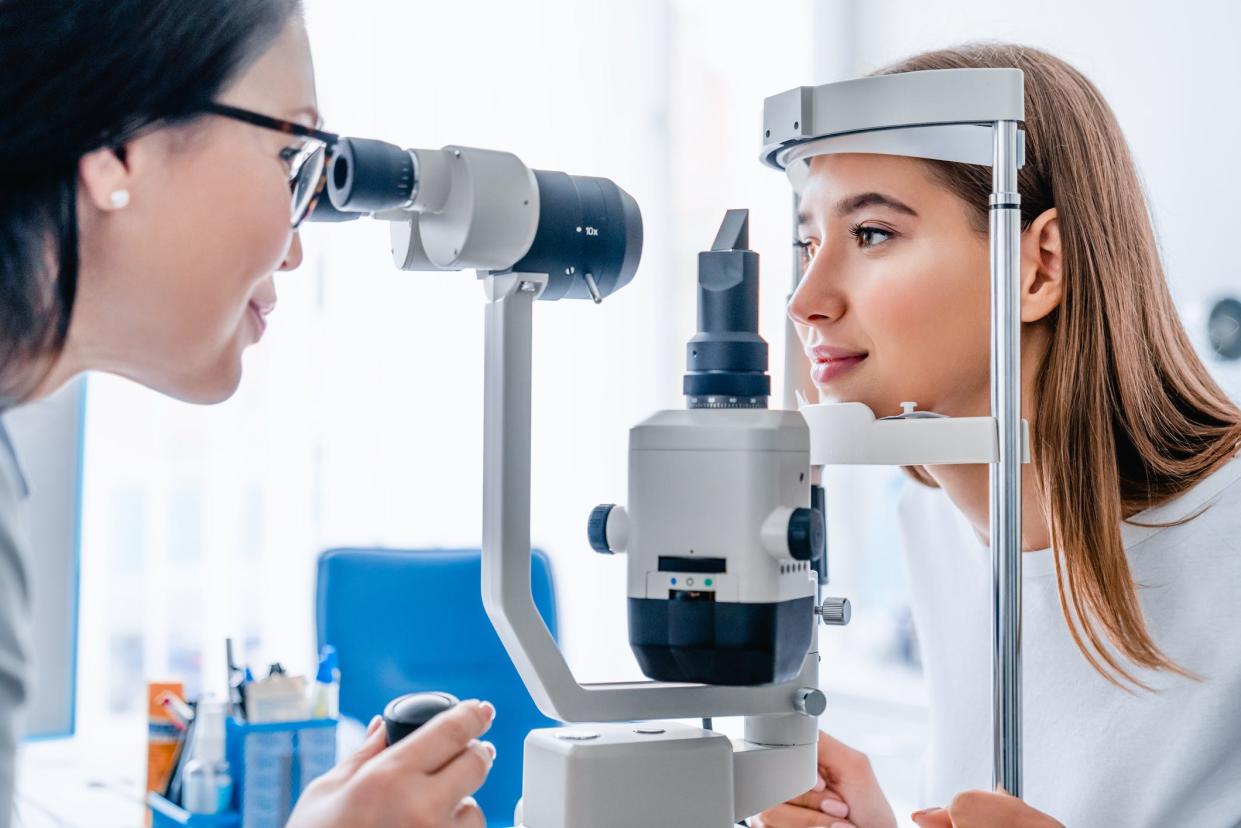 An ophthalmologist examines the eyes of a patient.