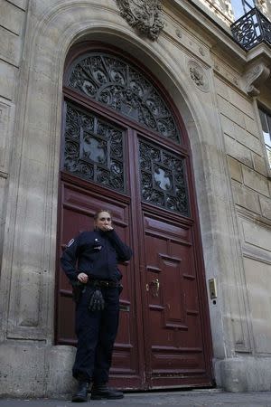 A police officer stands guard at the entrance of a luxury residence on the Rue Tronchet in central Paris, France, October 3, 2016 where masked men robbed U.S. reality TV star Kim Kardashian West at gunpoint early on Monday, stealing jewellery worth millions of dollars, police and her publicist said. REUTERS/Gonzalo Fuentes