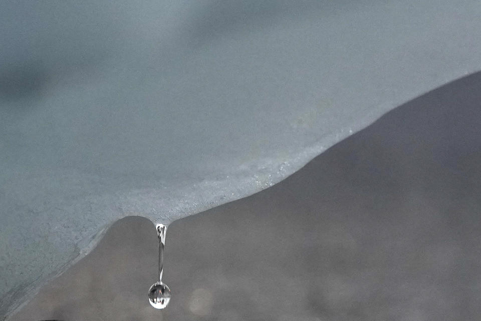 A droplet of water falls from an iceberg delivered by members of Arctic Basecamp is placed on show near the COP26 U.N. Climate Summit in Glasgow, Scotland, Friday, Nov. 5, 2021. The four ton block of ice, originally part of a larger glacier, was brought from Greenland to Glasgow by climate scientists from Arctic Basecamp as a statement to world leaders of the scale of the climate crisis and a visible reminder of what Arctic warming means for the planet. (AP Photo/Alastair Grant)