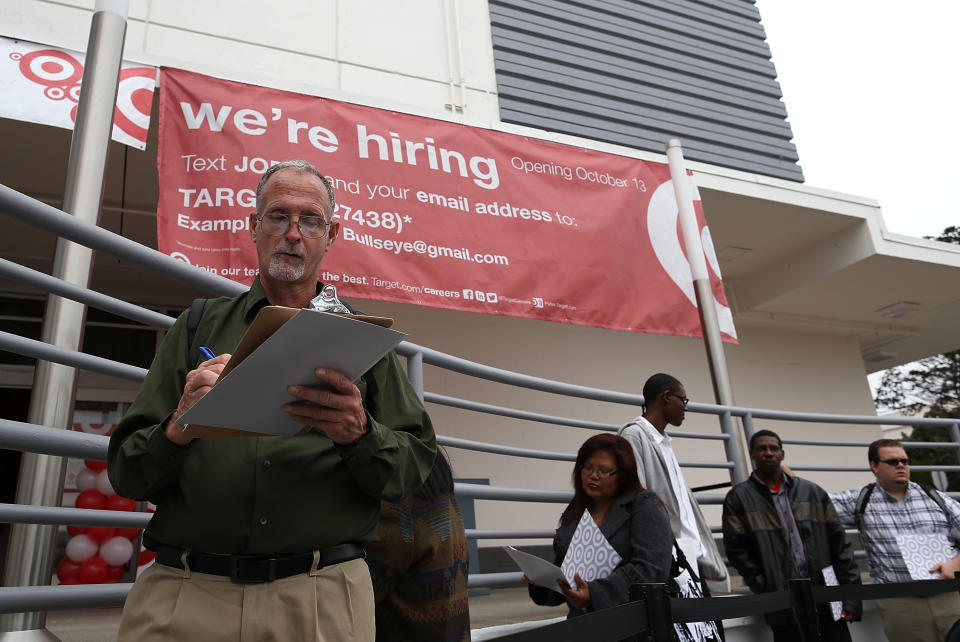 SAN FRANCISCO, CA - AUGUST 15:  Job seekers fill out applications as they wait in line to enter a job fair at a new Target retail store on August 15, 2013 in San Francisco, California. Hundreds of job seekers applied for jobs during a job fair to staff a new Target City store. According to a report by the Labor Department, the number of people seeking first time unemployment benefits fell to the lowest level since 2007 with initial jobless claims decreasing by 15,000 to 320,000. (Photo by Justin Sullivan/Getty Images)