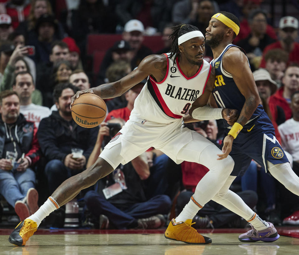 Portland Trail Blazers forward Jerami Grant, left, dribbles into Denver Nuggets forward Bruce Brown during the first half of an NBA basketball game in Portland, Ore., Monday, Oct. 24, 2022. (AP Photo/Craig Mitchelldyer)