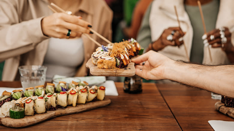 millenials eating aesthetic sushi