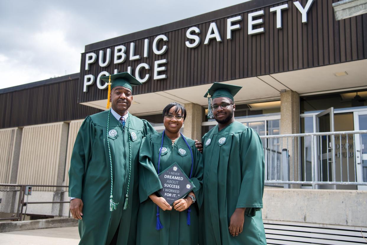 Pat(left), the fahter, poses with his son and daughter, Regan and Ryan, in front of the Eastern Michigan University Public Safety Department where he worked for 20 years. (Credit: Eastern Michigan University) 