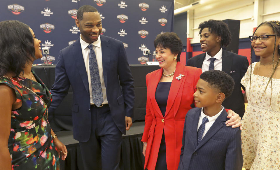 New Orleans Pelicans Governor Gayle Benson chats with Willie Green and his family after Green was introduced as the new head coach for the New Orleans Pelicans NBA basketball team, in Metairie, La., Tuesday, July 27, 2021. From left to right is Green's wife Terrah, Willie Green, Gayle Benson, son Ross, 21, daughter Aaliyah, 14, and son Mason, 9. (AP Photo/Ted Jackson)