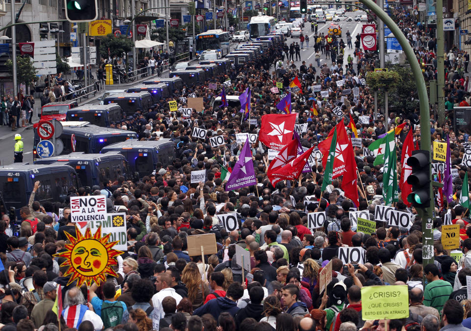 Protestors march to the parliament against austerity measures announced by the Spanish government, in Madrid, Spain, Tuesday, Sept. 25, 2012. Spain's Parliament has taken on the appearance of a heavily guarded fortress with dozens of police blocking access from every possible angle, hours ahead of a protest against the conservative government's handling of the economic crisis. The demonstration, organized behind the slogan 'Occupy Congress,' is expected to draw thousands of people. It is due to start around 1730 GMT Tuesday. Madrid authorities said some 1,300 police would be deployed. The protestors call for Parliament to be dissolved and fresh elections held, claiming the government's austerity measures show the ruling Popular Party misled voters to get elected last November. (AP Photo/Andres Kudacki)