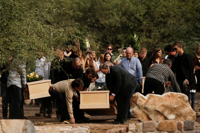 Relatives carry the remains of Dawna Ray Langford and her sons Trevor, Rogan, who were killed by unknown assailants, to be buried at the cemetery in La Mora