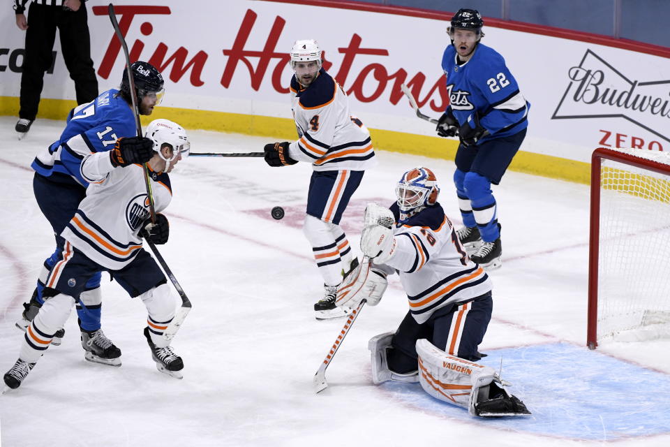 Edmonton Oilers goaltender Mikko Koskinen (19) makes a save against the Winnipeg Jets during the second period of an NHL hockey game, Sunday, Jan. 24, 2021 in Winnipeg, Manitoba. (Fred Greenslade/The Canadian Press via AP)