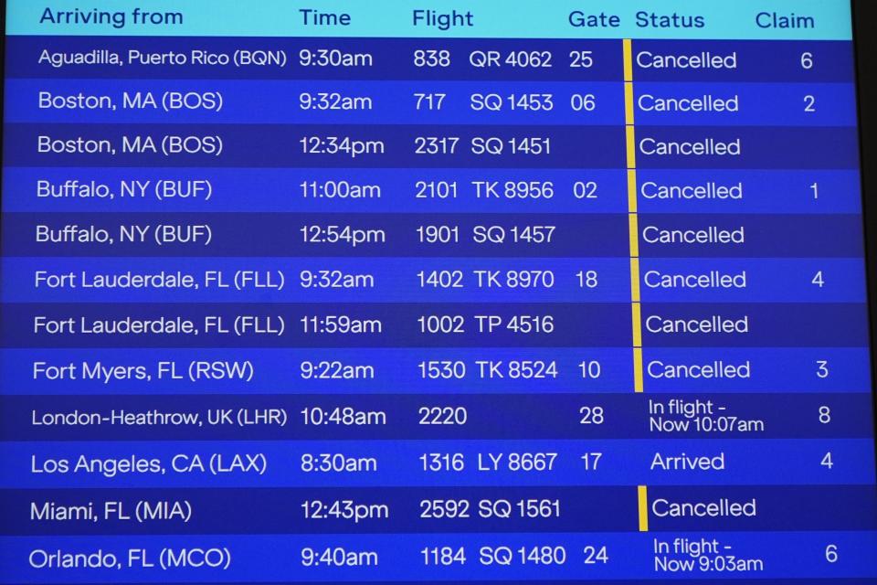 Flight cancellations are listed due to inclement weather are shown on an information board at John F. Kennedy International Airport Tuesday, Feb. 13, 2024, in New York. Parts of the Northeast were hit Tuesday by a snowstorm that canceled flights and schools and prompted warnings for people to stay off the roads, while some areas that anticipated heavy snow were getting less than that as the weather pattern changed. (AP Photo/Frank Franklin II)