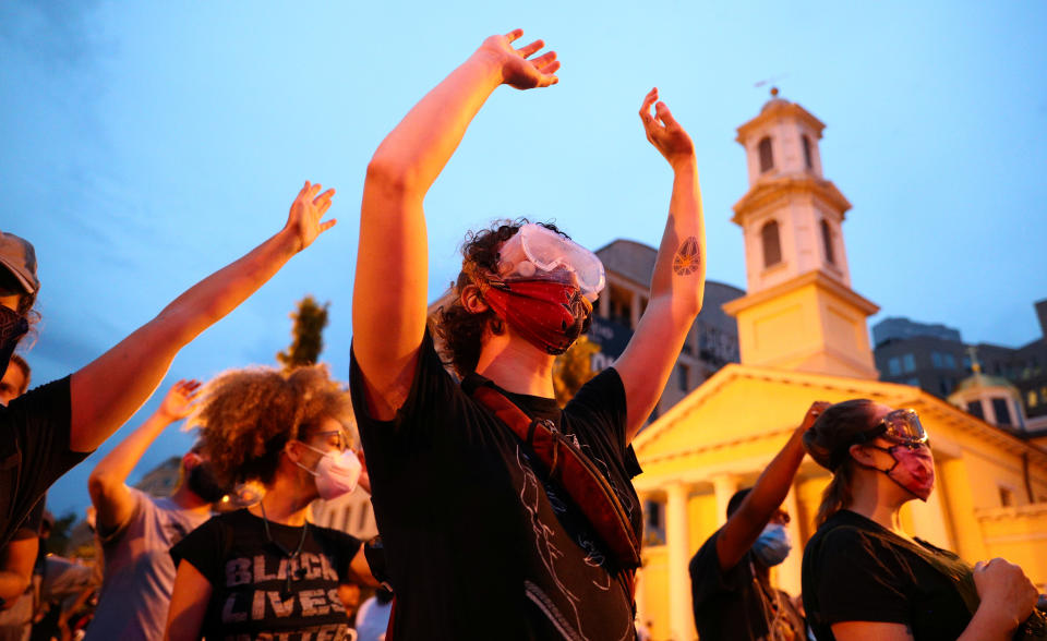 Protestors stand with their hands up on Black Lives Matter Plaza in front of St. John's Episcopal Church after police clashed with demonstrators trying to pull down the statue of U.S. President Andrew Jackson in Lafayette Park across from the White House during racial inequality protests in Washington, U.S., June 22, 2020. (Tom Brenner/Reuters)