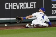 Kansas City Royals left fielder Alex Gordon can't catch a foul ball hit by Detroit Tigers' Victor Reyes during the seventh inning of a baseball game Thursday, Sept. 24, 2020, in Kansas City, Mo. (AP Photo/Charlie Riedel)