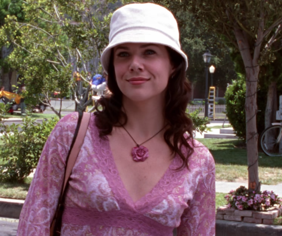 Okay, I'll give Lorelai retroactive points for the bucket hat, which has seen a resurgence of late, but there's simply no excuse for the tacky rose pendant and straight-from-Delias lacy pink shirt she's wearing.