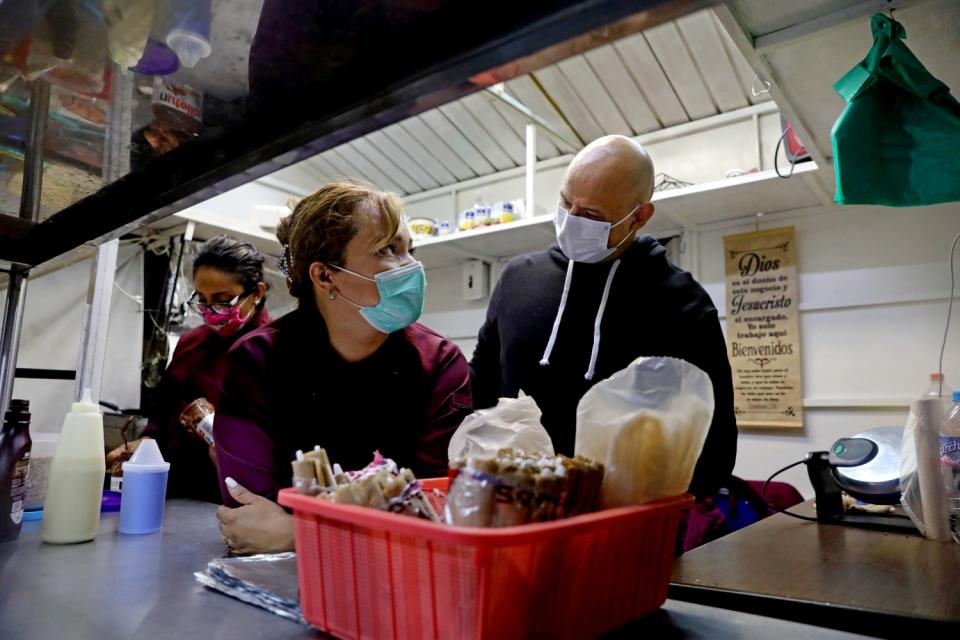 Wrestler Joel Bernal Galicia makes crepes with his wife, Leticia Vazquez Rojano, left.