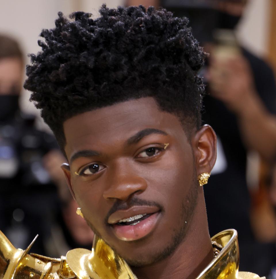 Lil Nas X wears a regal gold armor-inspired outfit