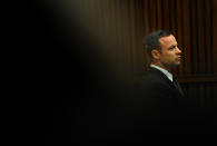 Oscar Pistorius, listens as he sits in the dock waiting for proceedings to begin in court in Pretoria, South Africa, Tuesday, March 18, 2014. Pistorius is on trial for the murder of his girlfriend Reeva Steenkamp on Valentines Day, 2013. (AP Photo/Werner Beukes, Pool)