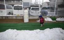 A girl runs past a geiger counter, measuring a radiation level of 0.122 microsievert per hour, upon her arrival at the Emporium kindergarten in Koriyama, west of the tsunami-crippled Fukushima Daiichi nuclear power plant, Fukushima prefecture February 28, 2014. REUTERS/Toru Hanai