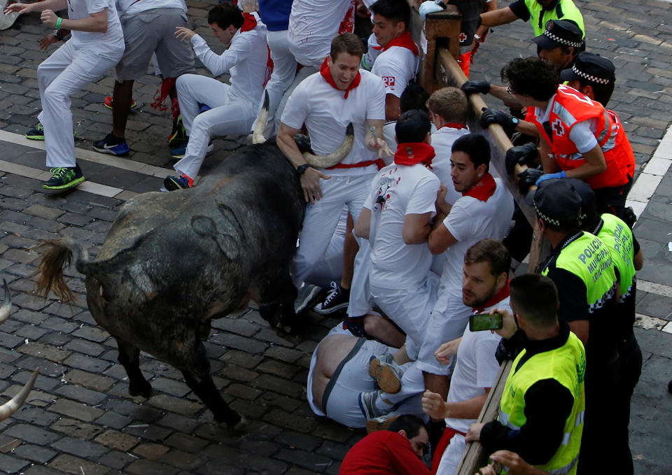 <p>A runner is trapped on the horns of a Cebada Gago bull during the first running of the bulls at the San Fermin festival in Pamplona, northern Spain, July 7, 2017. (Joseba Etxaburu/Reuters) </p>