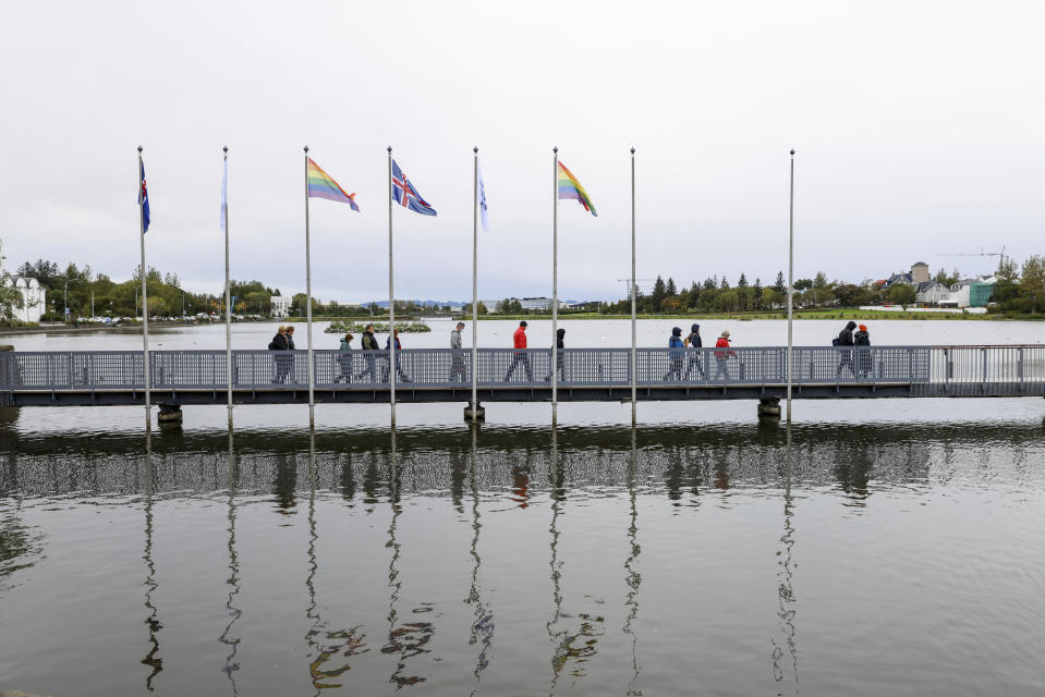 People arrive at a polling station in Reykjavik, Iceland, Saturday, Sept. 25, 2021. Iceland is heading to the polls for general elections on Saturday with nine parties running for seats at the North Atlantic island nation's Parliament, or Althing. Polls suggest Prime Minister Katrin Jakobsdottir's Left Green Party could face a poor outcome, ending the current coalition. (AP Photo/Brynjar Gunnarsson)