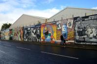 Belfast’s trials and tribulations find expression in walls. A Peace Wall more than 20 feet high separates the Nationalists and the Unionists today.