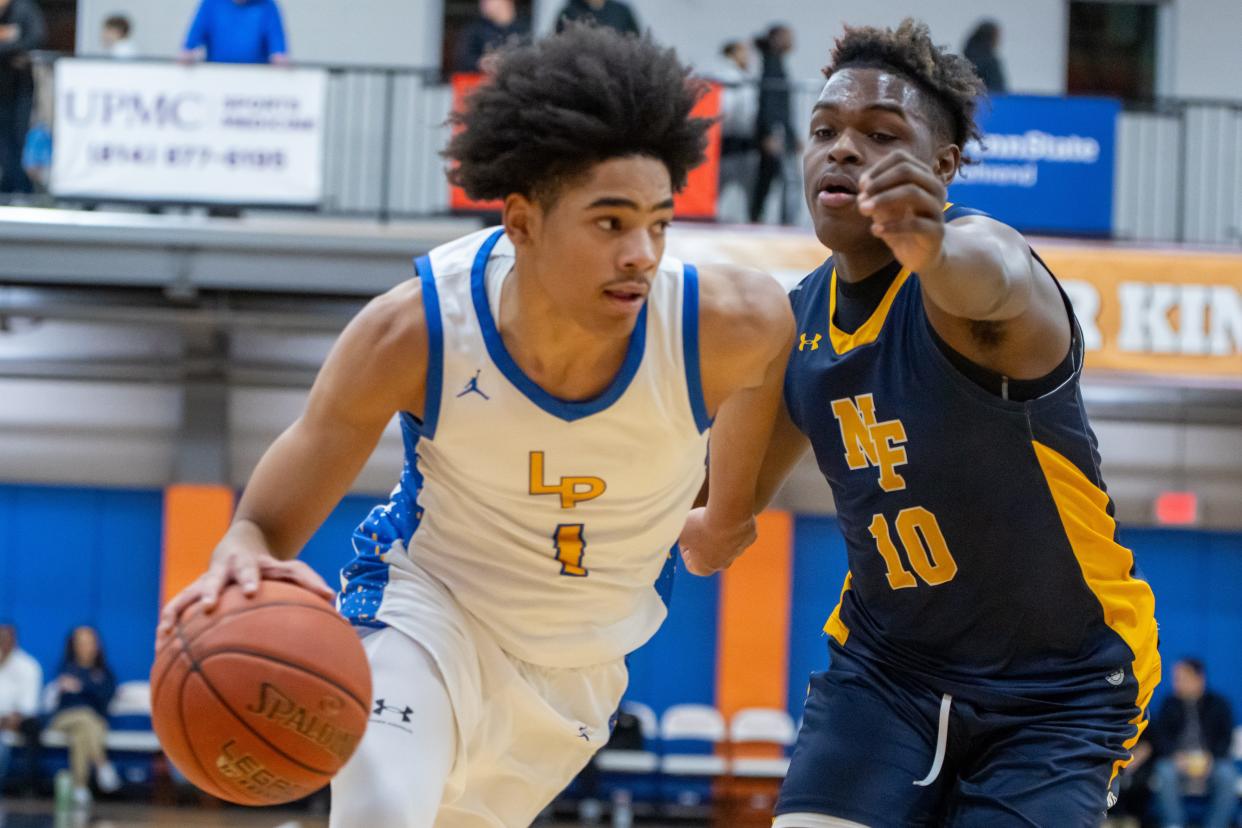 Rhaki Lum (1) drives to the hoop while being guarded by Niagara Falls’ Omarion Ralands (10) Friday night in the 2024 Burger King Classic semifinal matchup.