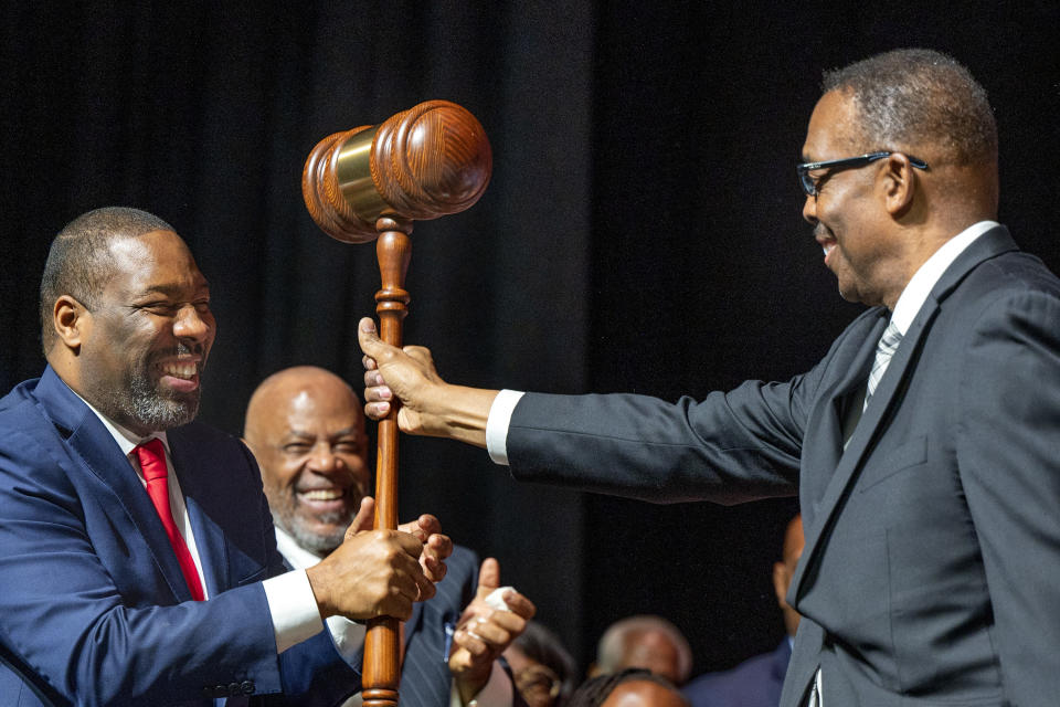 Outgoing Philadelphia City Council President Darrell Clarke, right, hands over an oversized gavel to newly-elected City Council President Kenyatta Johnson during inauguration ceremonies, Tuesday, Jan. 2, 2024, at the Met in Philadelphia. (Tom Gralish/The Philadelphia Inquirer via AP)