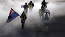 Peter Crooks of the British Virgin Islands holds his country's national flag and enters with his team during the opening ceremony of the 2014 Winter Olympics in Sochi, Russia, Friday, Feb. 7, 2014. (AP Photo/Charlie Riedel)