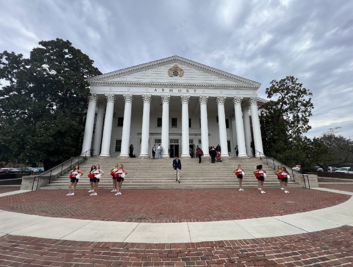 Cheerleaders assemble outside Reckord Armory Oct. 27, 2023 on the campus of the University of Maryland, College Park for a launch event for the Maryland Service Year Option program.