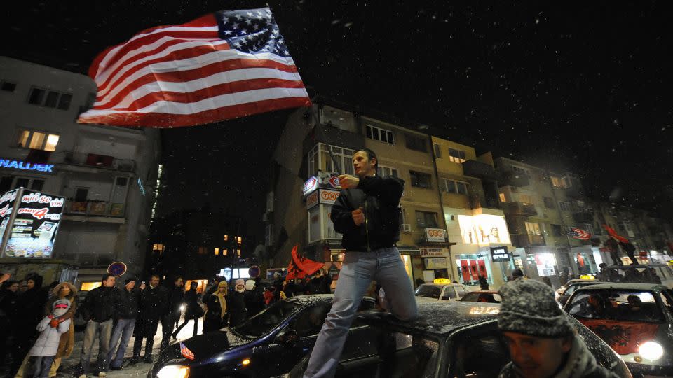 A Kosovar local waves a US flag as  thousands celebrated the announcement of the independence of Kosovo, in February 2008. - Daniel Mihailescu/AFP/Getty Images/File