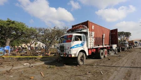 Trailers are seen parked outside a police cordon after a suicide car bomb went off at the entrance of Somalia's biggest port in its capital Mogadishu December 11, 2016. REUTERS/Feisal Omar