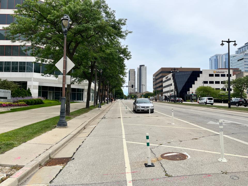 On-street parking spaces and posts create a buffer between bike and car traffic along Kilbourn Avenue in downtown Milwaukee.