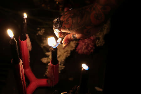 A self-proclaimed witch lights a candle before a ceremony hexing U.S. Supreme Court Justice Brett Kavanaugh at Catland Books in Brooklyn, New York, U.S., October 20, 2018. REUTERS/Shannon Stapleton