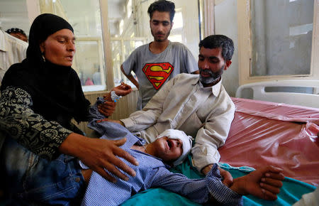 Parents comfort their son whom they say was injured by pellets shot by security forces in Srinagar following weeks of violence in Kashmir, August 18, 2016. REUTERS/Cathal McNaughton