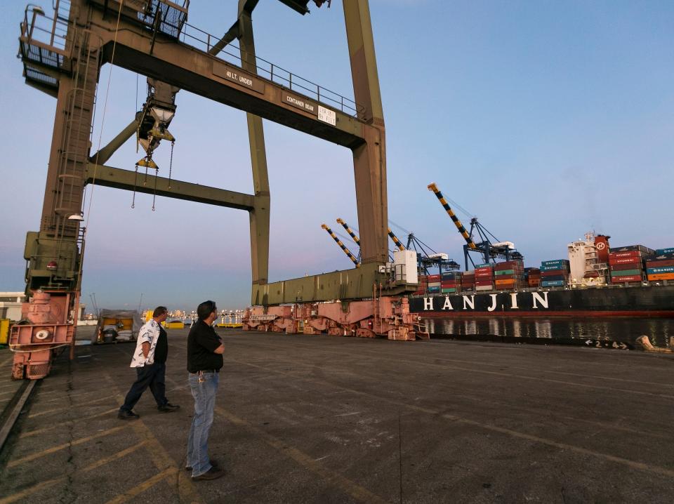 Jan. 14, 2015 photo, International Longshore and Warehouse Union, ILWU members visit an empty dock at the Port of Los Angeles. Employers could lock out West Coast dockworkers in as few as five days if the two sides do not reach a new contract. The warning came Wednesday, Feb. 4, 2015, from the head of a maritime association who is negotiating a new deal with a union representing longshoremen at 29 ports that handle about $1 trillion in trade annually.