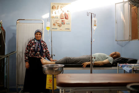 A man lies on a bed inside a clinic, a former school renamed Martyr Khaled Fajr hospital in Aleppo's Sheikh Maqsoud neighbourhood, Syria July 15, 2017. REUTERS/Omar Sanadiki