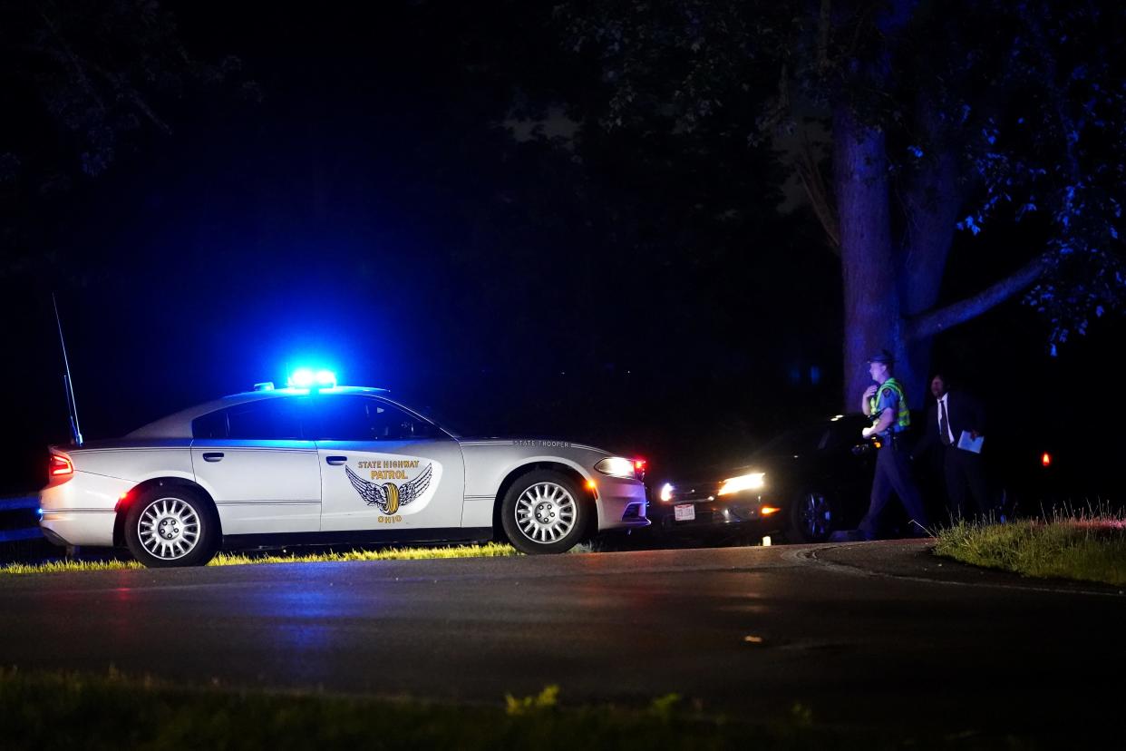 Authorities investigate a shooting in which a Clearcreek Township police officer was shot in the head responding to a domestic violence call, Tuesday, July 12, 2022, in the 5900 block of Ohio 48. Clearcreek Township Police Chief John Terrill said two of his officers responded to a domestic violence call Tuesday evening. A male subject was ramming his wife's car with an ATV.