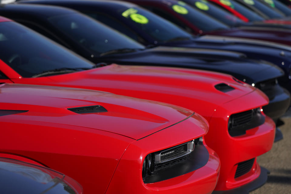 This Jan. 24, 2021 photo shows a long line of used Challengers at a Dodge dealership in Littleton, Colo. In 2021, high demand and low supply have driven up used vehicle prices so much that many are now selling for more than their original sticker price when they were new. (AP Photo/David Zalubowski)