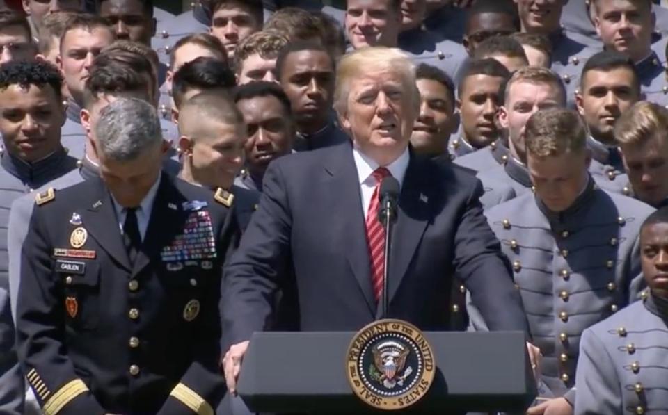 President Donald Trump presents the Commander-in-Chief's Trophy to the Army Black Knights college football team during a ceremony at the White House on May 1, 2018. <cite>The White House</cite>