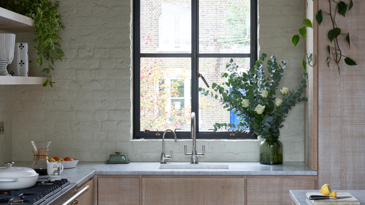  Wooden kitchen with green walls. 