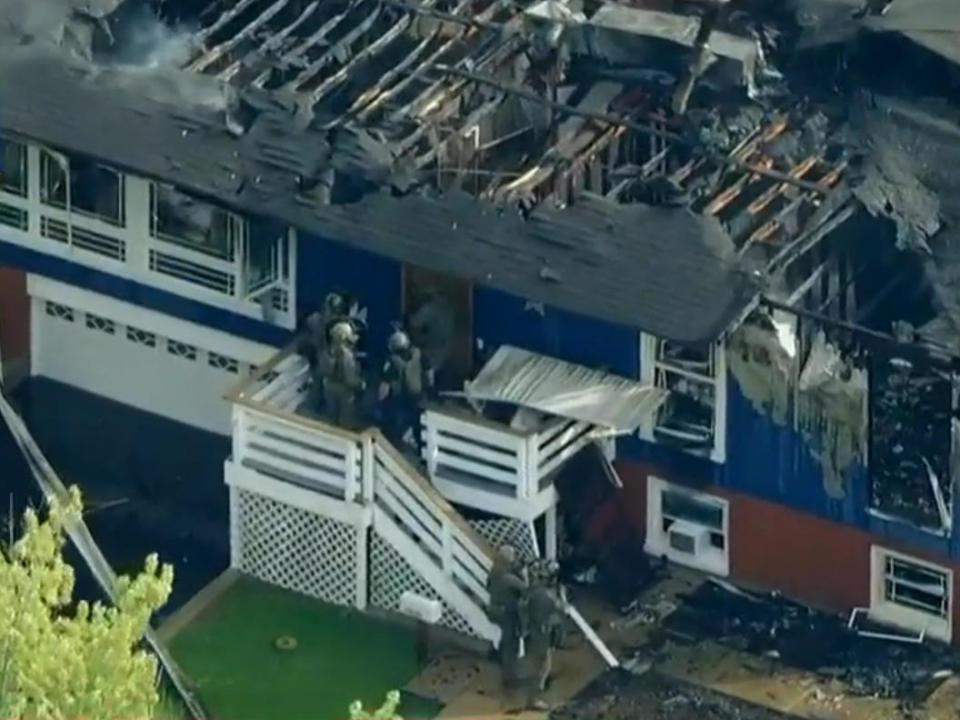Authorities attempt to enter a house in Oak Forest, Illinois, after the house caught fire during an incident Sept. 23, 2022. / Credit: WBBM-TV