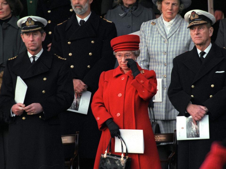 PORTSMOUTH, UNITED KINGDOM - DECEMBER 11: The Queen Wiping A Tear From Her Eye At The De-commissioning Ceremony For Hmy Britannia. With Her Are Prince Philip And Prince Charles.