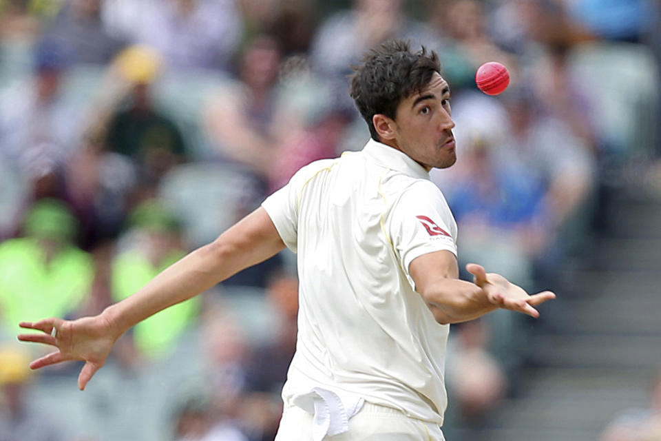 FILE - In this Dec. 4, 2017, file photo, Australia's Mitchell Starc reaches out to take the wicket of England's Jonny Bairstow, caught and bowled for 21 runs, during their Ashes cricket test match in Adelaide, Australia. Starc hasn't picked up a cricket bat or ball in two months, and isn't exactly salivating at the prospect of going back to work. (AP Photo/Rick Rycroft, File)